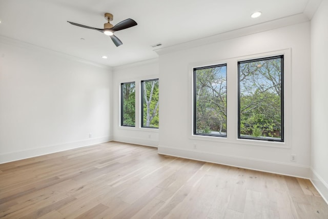 empty room with ceiling fan, light wood-type flooring, and crown molding