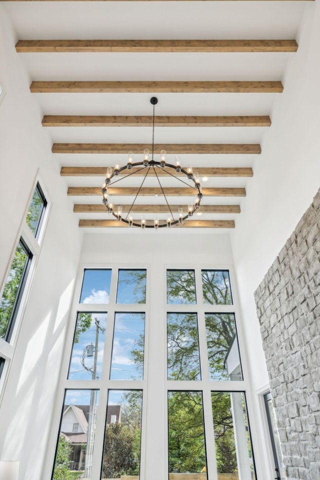 interior details with a notable chandelier and beam ceiling