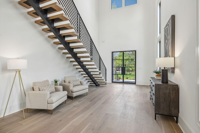 entrance foyer with light hardwood / wood-style flooring and a high ceiling