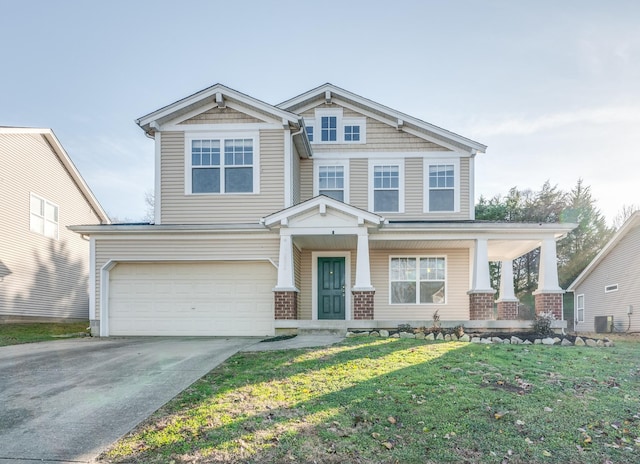 craftsman-style home with a porch, a garage, and a front yard