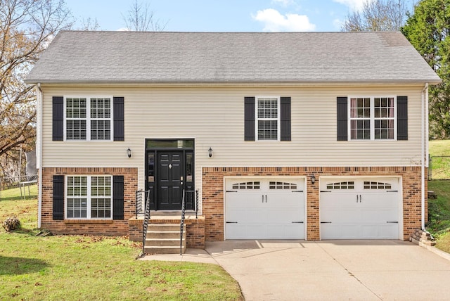 split foyer home featuring a front lawn and a garage