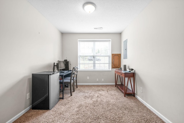 office space with electric panel, light carpet, and a textured ceiling