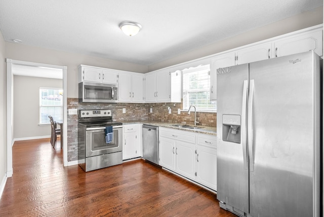 kitchen featuring sink, white cabinets, stainless steel appliances, and dark hardwood / wood-style floors