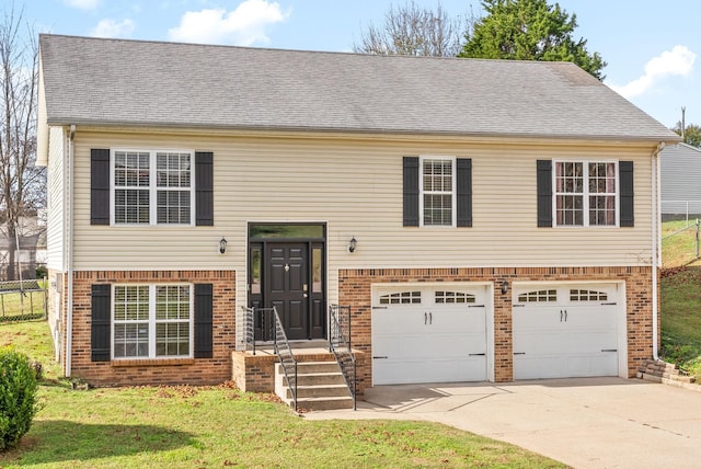 bi-level home featuring a front lawn and a garage