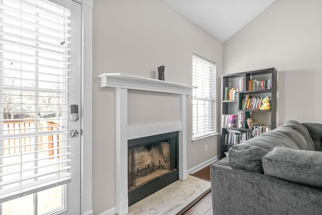 sitting room featuring wood-type flooring, a wealth of natural light, and vaulted ceiling