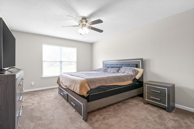 carpeted bedroom featuring a textured ceiling and ceiling fan