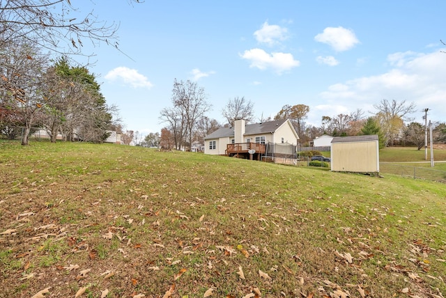 view of yard featuring a shed and a wooden deck