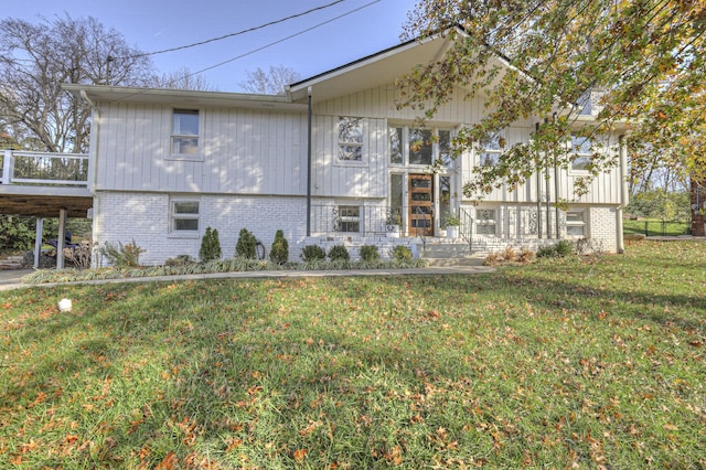 view of front of house with a front yard and a carport