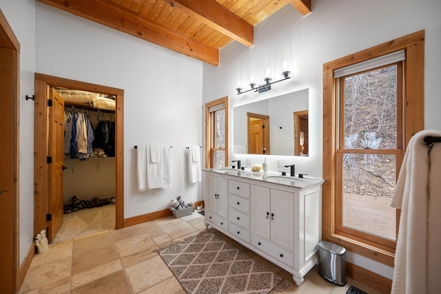 bathroom featuring beamed ceiling, vanity, wood ceiling, and a wealth of natural light