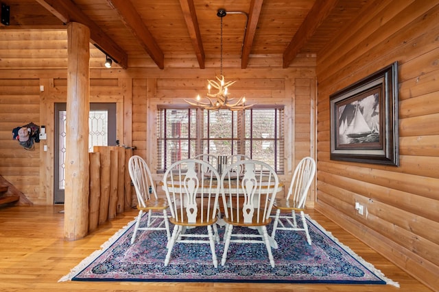 unfurnished dining area with beam ceiling, hardwood / wood-style flooring, an inviting chandelier, and wooden ceiling