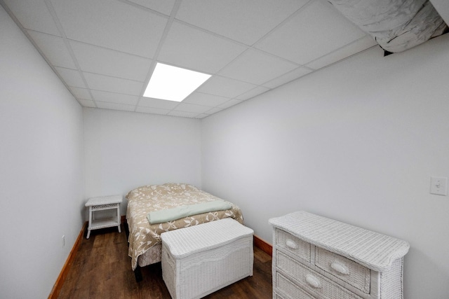 bedroom featuring dark hardwood / wood-style floors and a drop ceiling