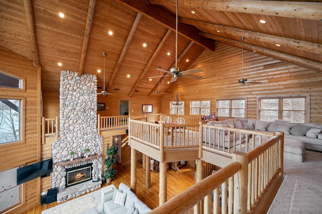 living room with wood ceiling, a wealth of natural light, high vaulted ceiling, and light hardwood / wood-style floors