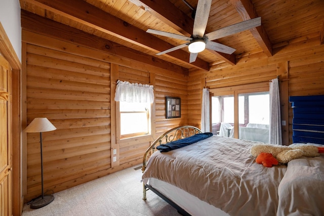 carpeted bedroom featuring beam ceiling, multiple windows, and wood ceiling