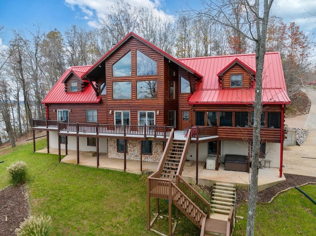 back of house with a patio, a hot tub, and a deck