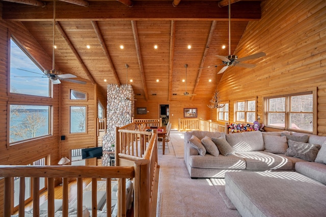 living room with beamed ceiling, high vaulted ceiling, and wood ceiling