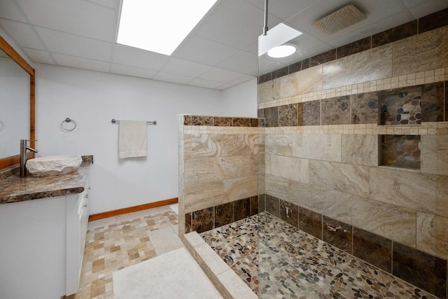 bathroom featuring a shower, vanity, and a paneled ceiling