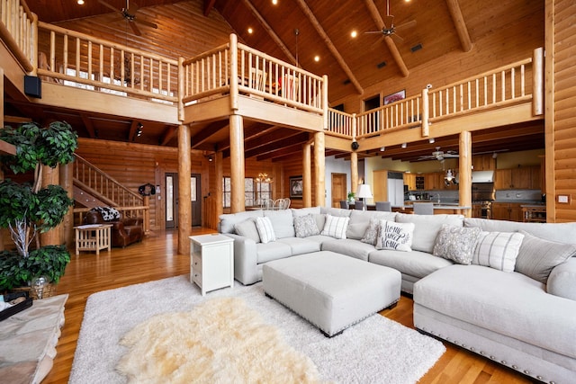 living room featuring beamed ceiling, high vaulted ceiling, wood ceiling, and hardwood / wood-style flooring