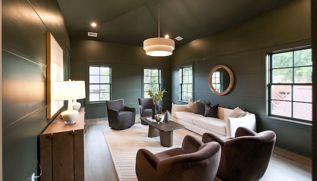 living room with lofted ceiling and wood-type flooring