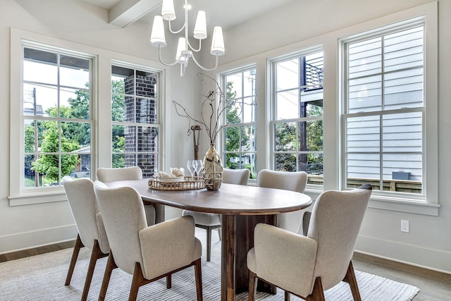 dining area featuring hardwood / wood-style flooring, a notable chandelier, and beam ceiling