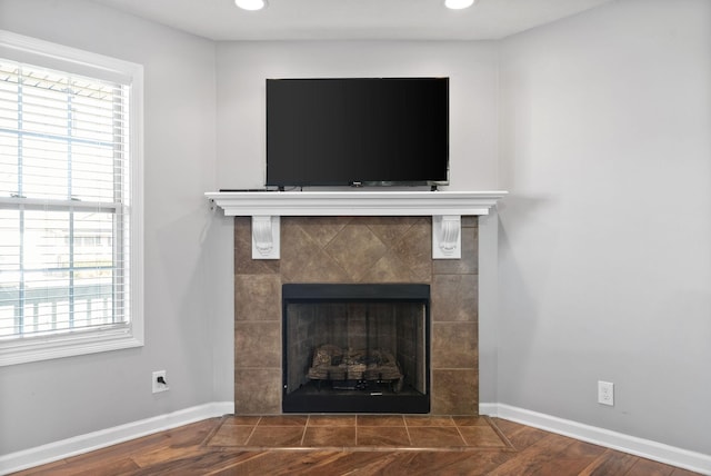 interior details featuring a fireplace and hardwood / wood-style flooring