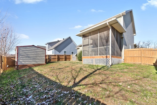 back of property featuring a yard and a sunroom