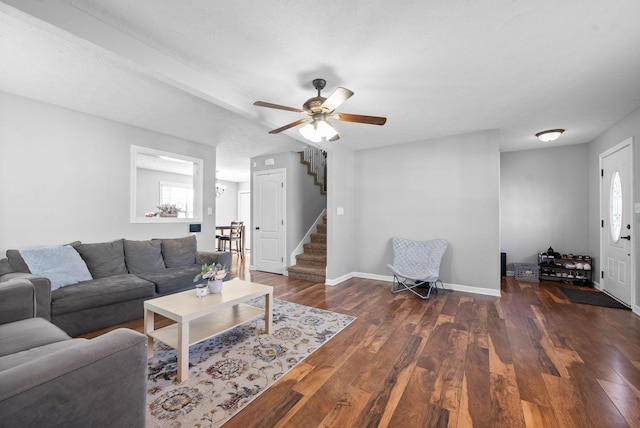 living room with dark hardwood / wood-style flooring and ceiling fan