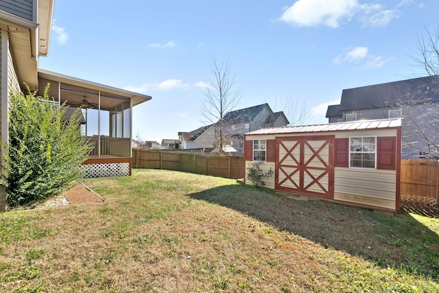 view of yard with ceiling fan and a storage shed