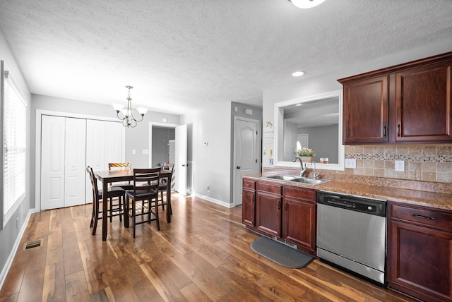 kitchen with stainless steel dishwasher, a notable chandelier, tasteful backsplash, dark hardwood / wood-style flooring, and sink