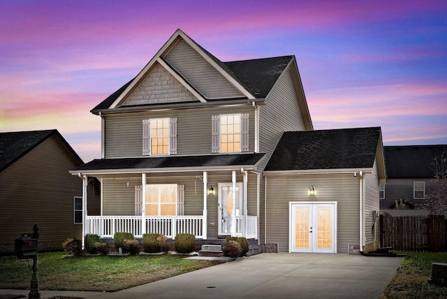 view of front of home with covered porch and french doors