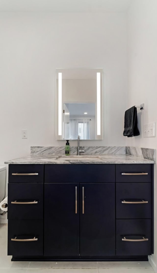 bathroom featuring vanity and toilet