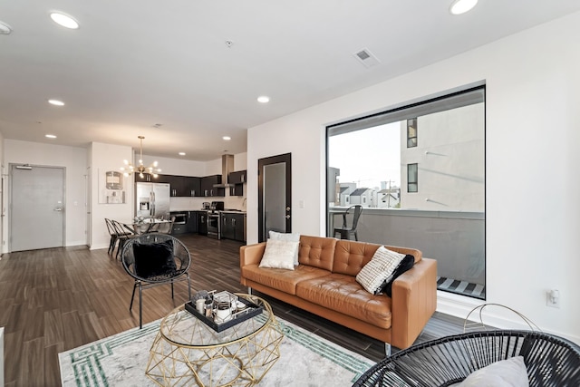 living room featuring dark hardwood / wood-style flooring and a notable chandelier