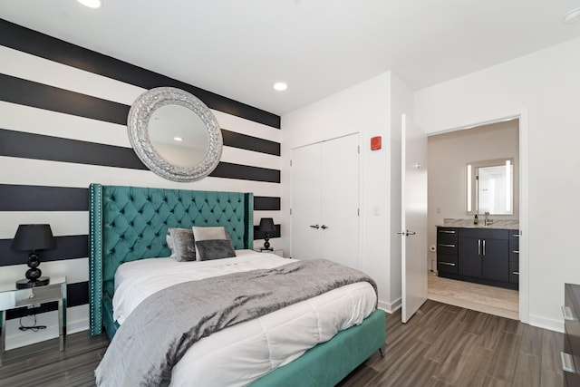 bedroom with a closet, sink, and dark wood-type flooring