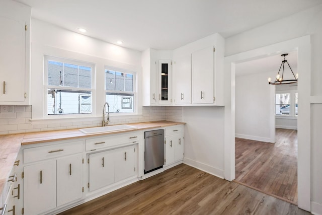 kitchen featuring white cabinets, pendant lighting, and sink