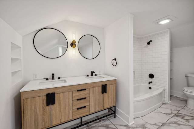 full bathroom with vanity, tiled shower / bath combo, and toilet