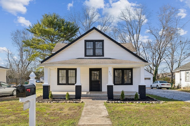 view of front of house with a front lawn and covered porch