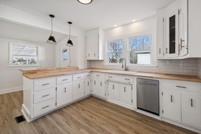 kitchen featuring pendant lighting, a healthy amount of sunlight, white cabinetry, and sink