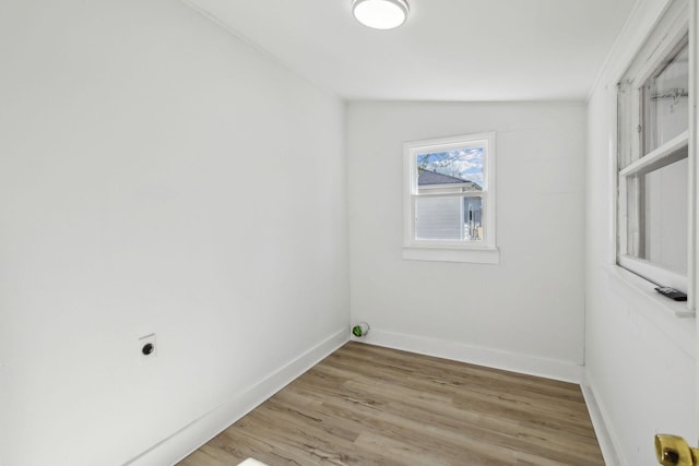 washroom with hardwood / wood-style flooring and electric dryer hookup