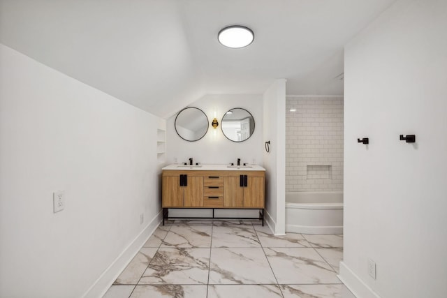 bathroom with tiled shower / bath combo and vanity