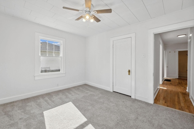 carpeted empty room with ceiling fan