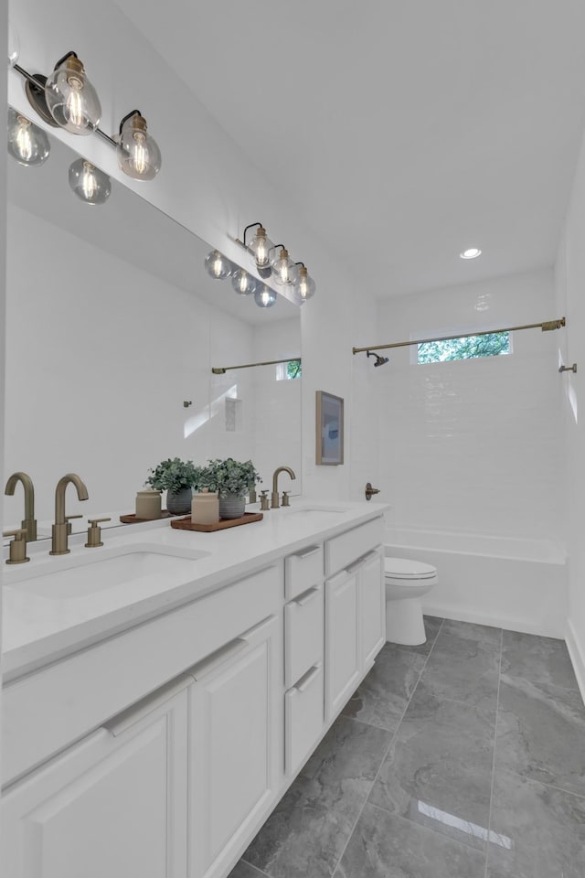 full bathroom featuring vanity, toilet, and tiled shower / bath combo