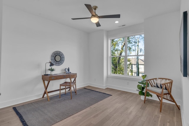 home office with ceiling fan and light wood-type flooring