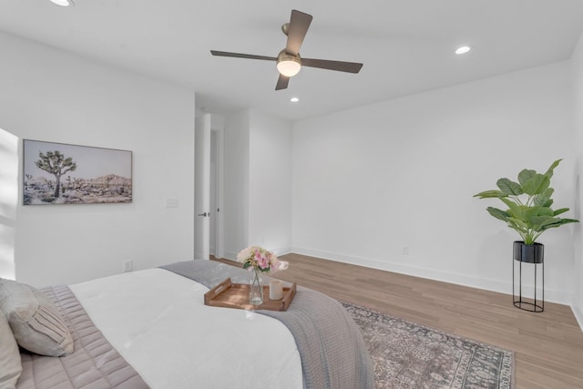 bedroom featuring ceiling fan and light hardwood / wood-style flooring