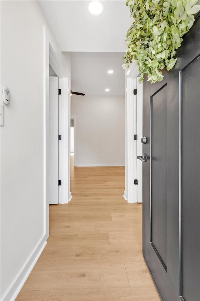 hallway with light hardwood / wood-style flooring