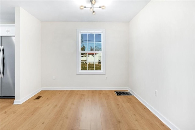 unfurnished room featuring light hardwood / wood-style floors