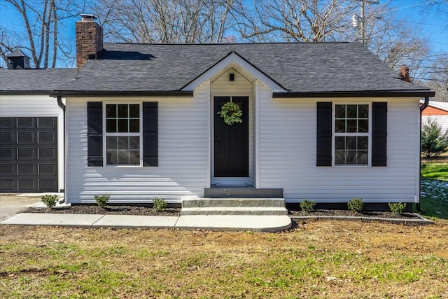 ranch-style house featuring a garage and a front yard