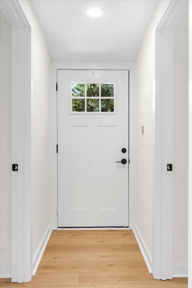 doorway to outside with wood-type flooring