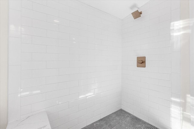 bathroom with a tile shower