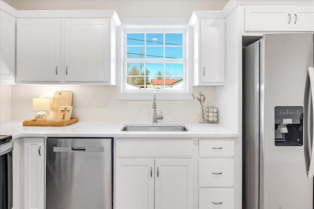 kitchen with sink, white cabinetry, and stainless steel appliances