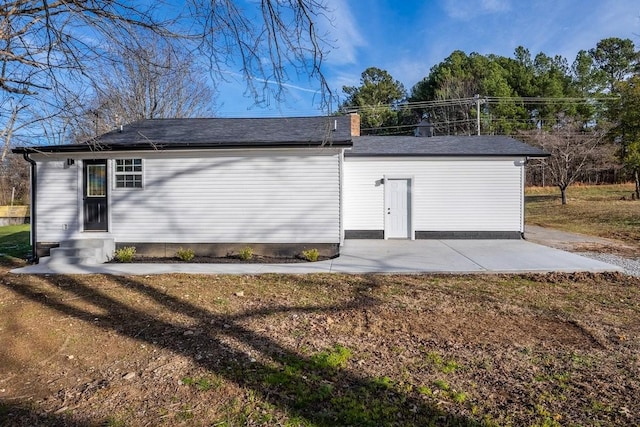 view of side of property with a patio area