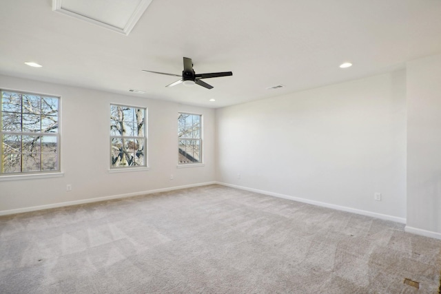 carpeted spare room featuring ceiling fan